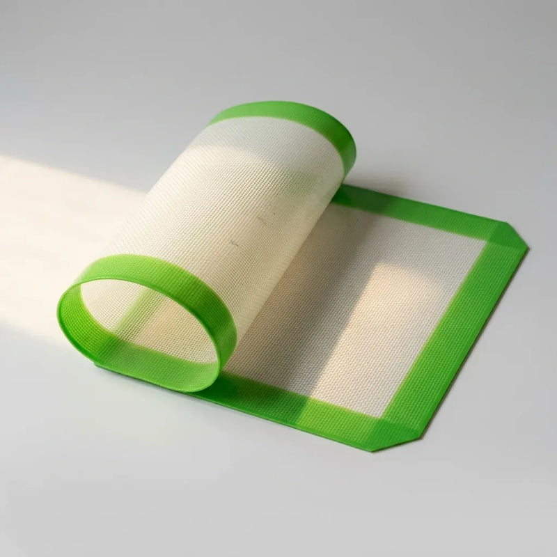 Flexible platinum silicone nonstick pad shown half rolled, studio detail