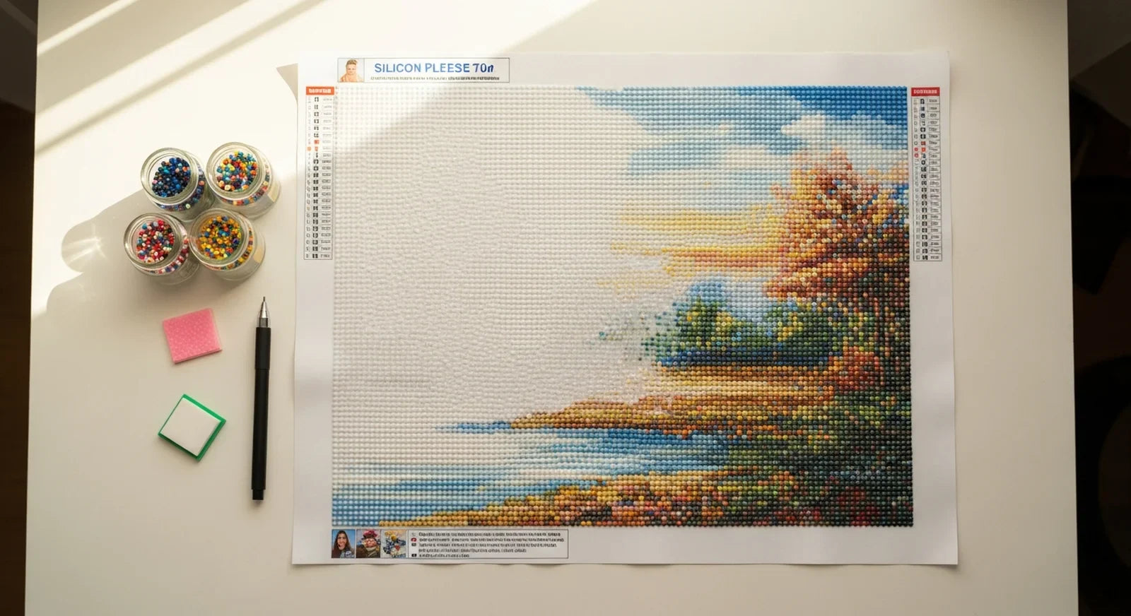 Large diamond painting canvas partially completed on craft table with sorted drill jars and tools