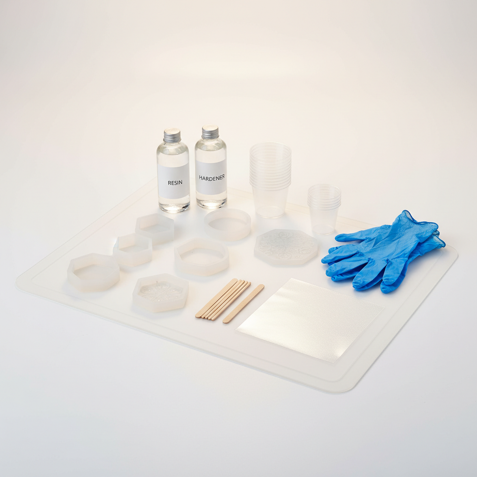 Complete resin crafting supply kit with epoxy, molds, mixing cups, and safety equipment