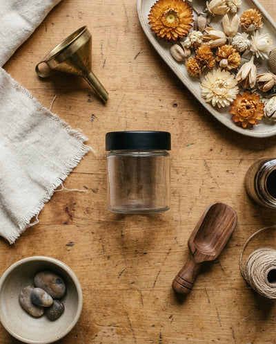 3oz Glass Jar with Black CR Lid — workspace flatlay