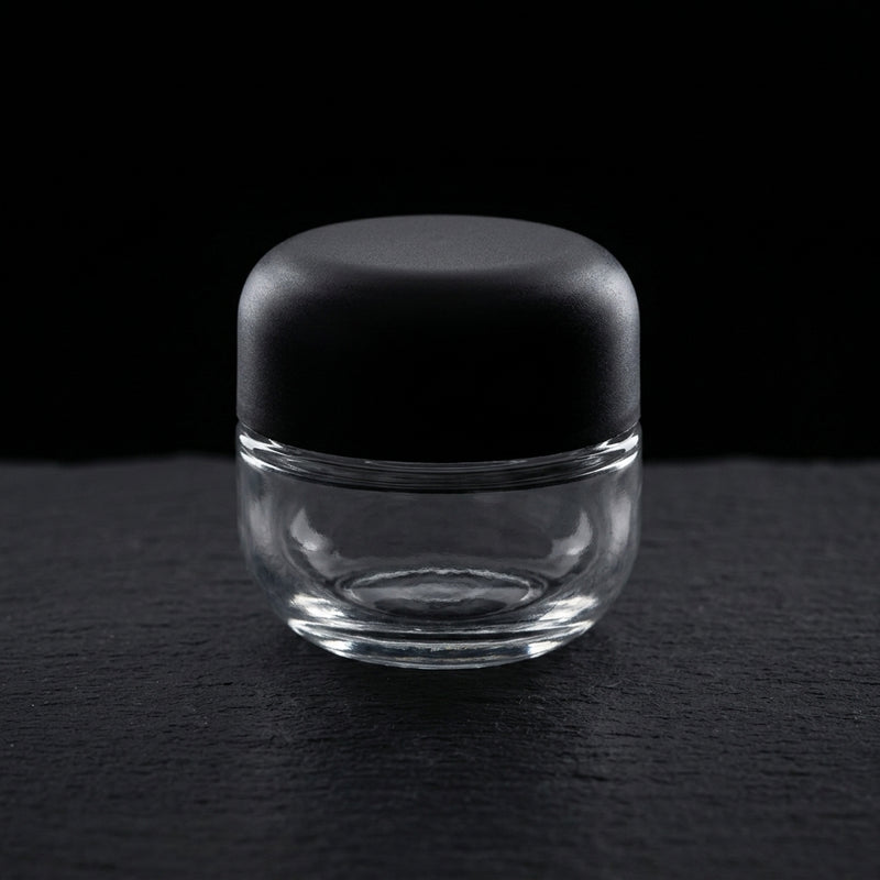 5ml Round Bottom Child Resistant Jar with domed black lid, editorial product shot