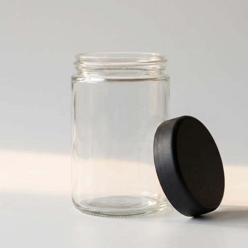 18 oz clear glass jar with child-resistant black lid removed, studio detail